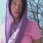 Jendhamuni wearing purple scarf