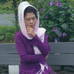 Jendhamuni near purple flowers at Wat Kiryvongsa on August 8, 2020